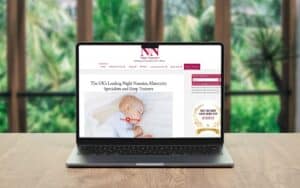 A serene image of a laptop displaying the Wildcurrant website, focusing on sleep training and night.