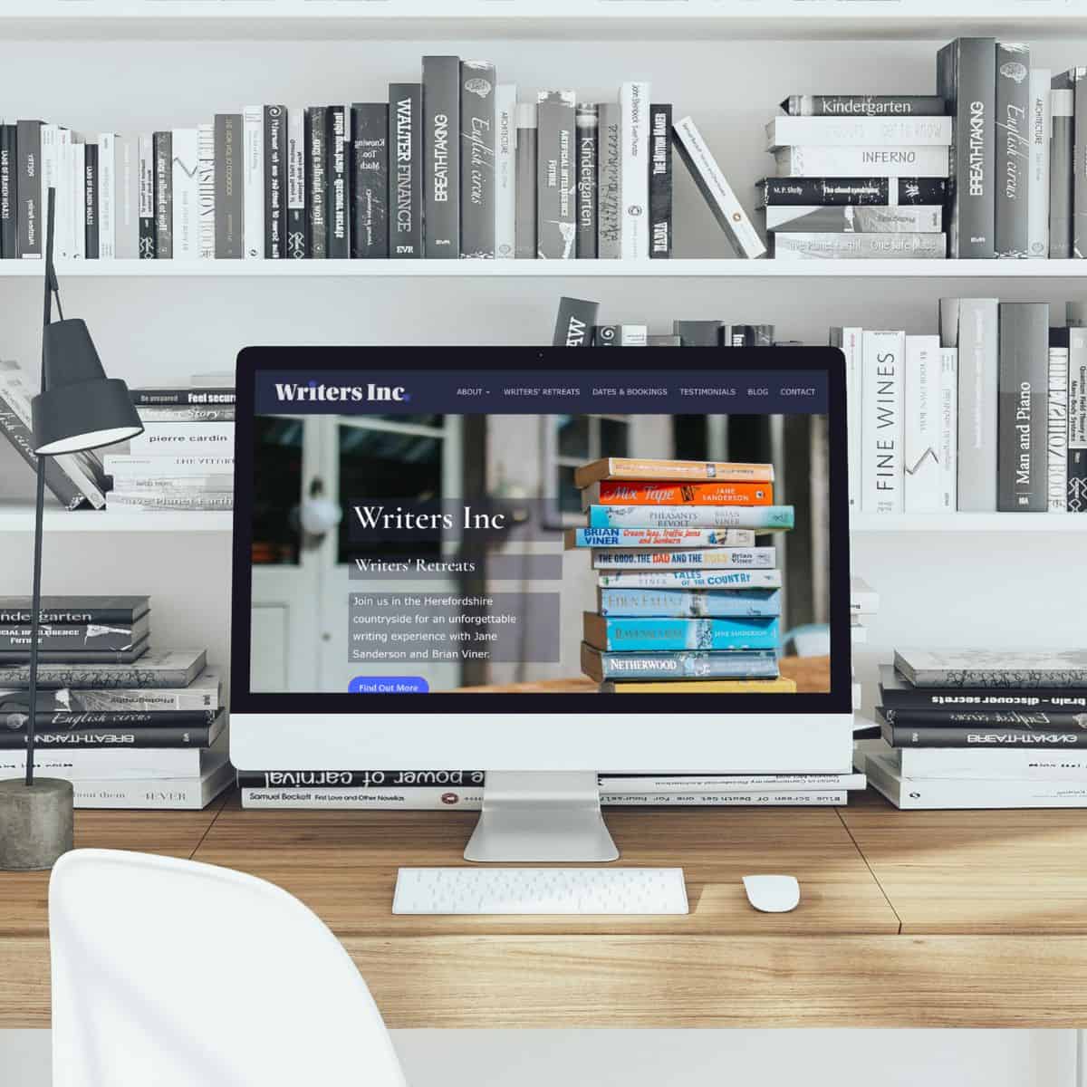 Modern workspace with books and computer for writers and creatives.